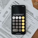A calculator and some papers on a table