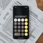 A calculator and some papers on a table