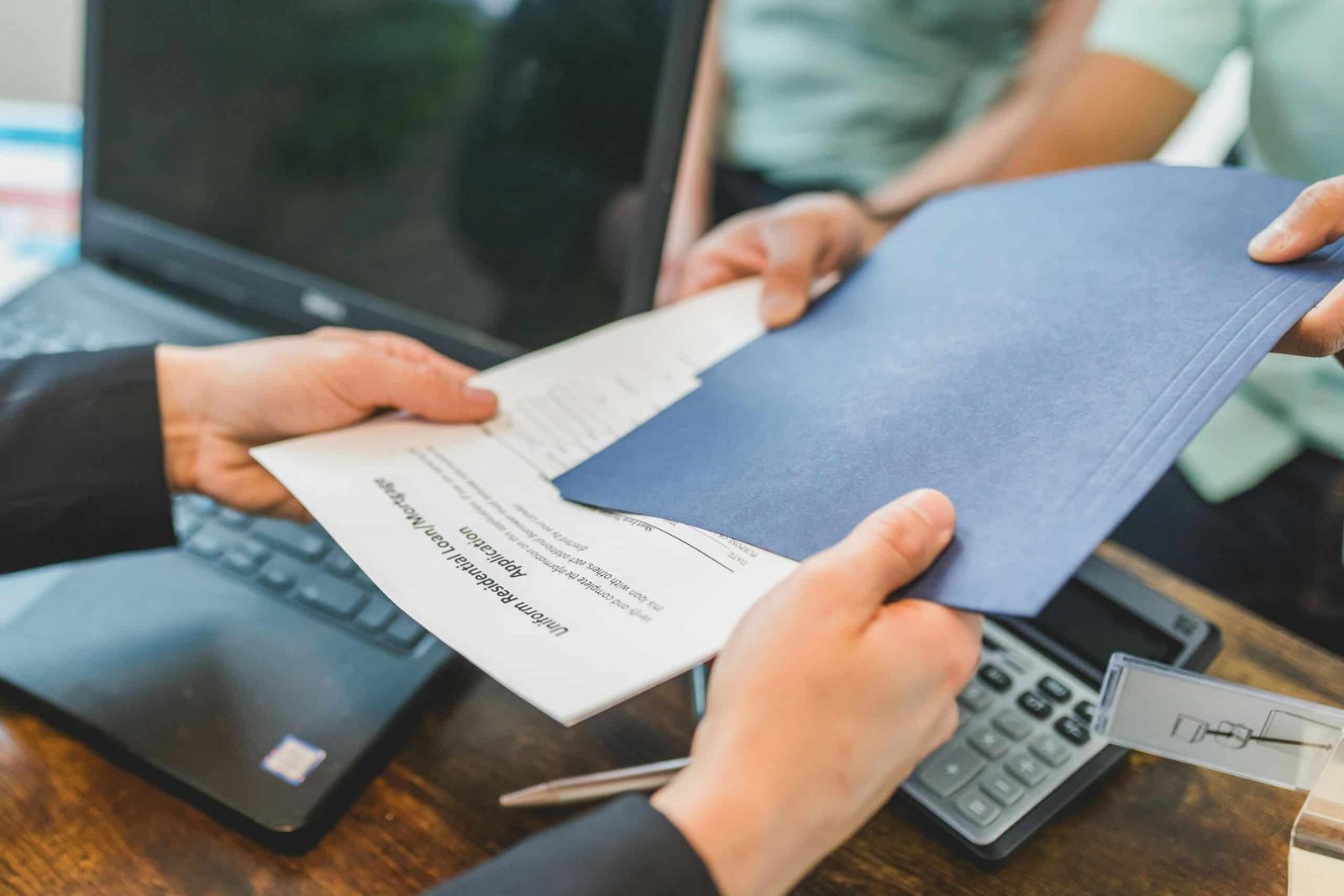 A woman giving mortgage papers to a man