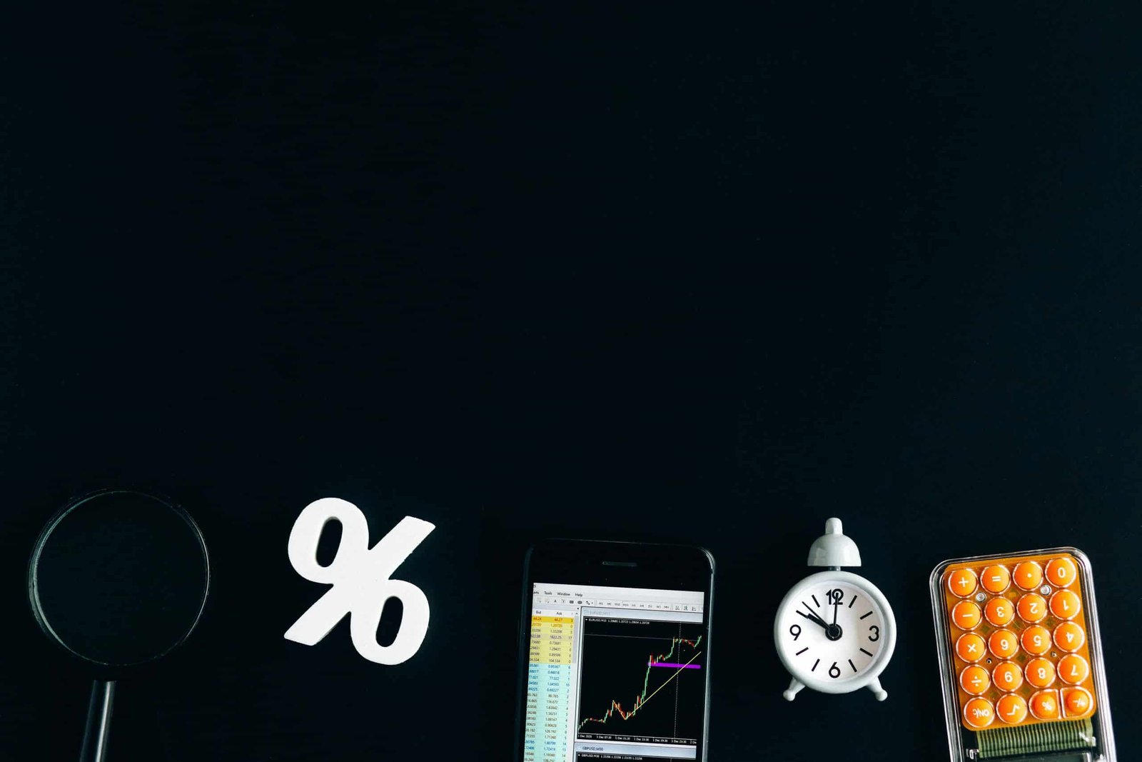 A Calculator and some devices with a black background.